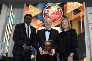 Mark Quigley accepts his Hall of Fame plaque from Naomi Ambrose of charity Talent Tap