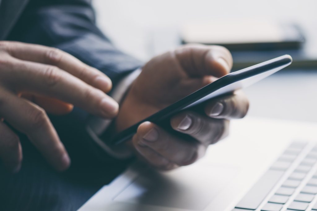 Closeup of a businessman's hands using a smartphone
