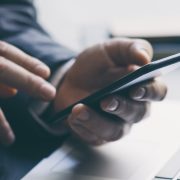 Closeup of a businessman's hands using a smartphone
